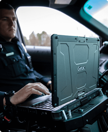 Policeman with laptop in the car.