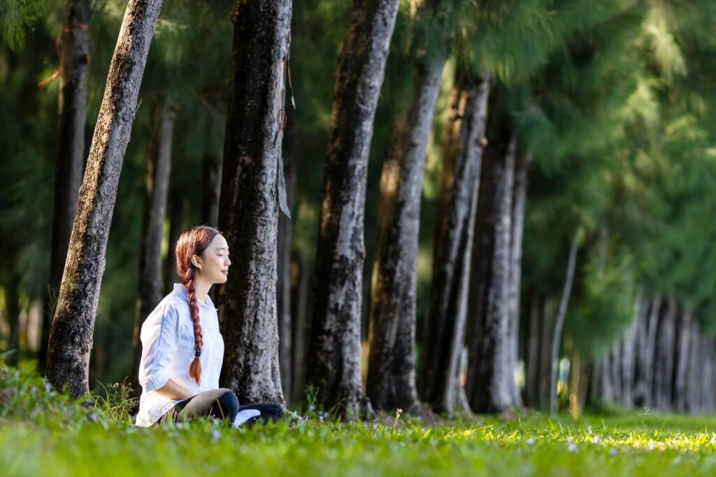 Woman meditating in the forest